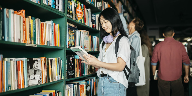 student reading book at bookshop