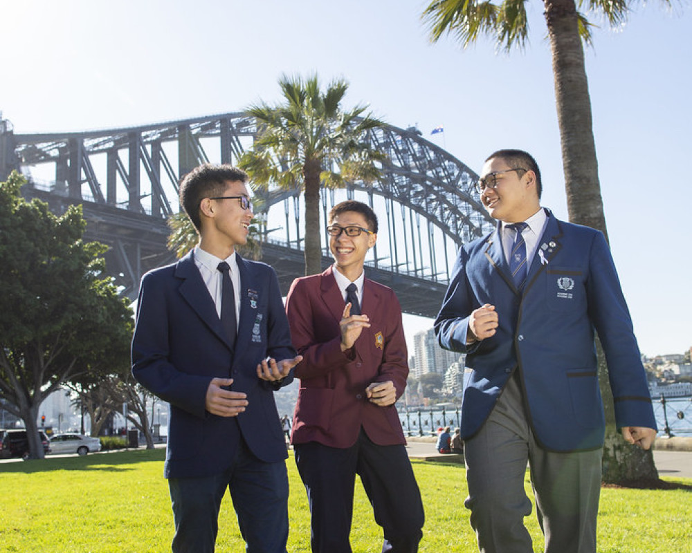 Trio of students outside Sydney Harbour Bridge