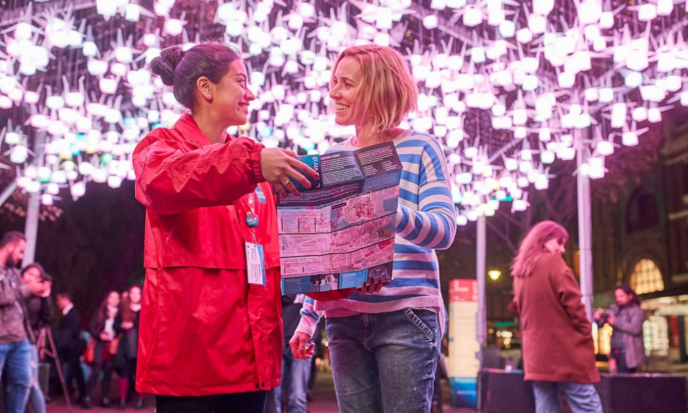 two volunteers looking at map at Vivid Sydney