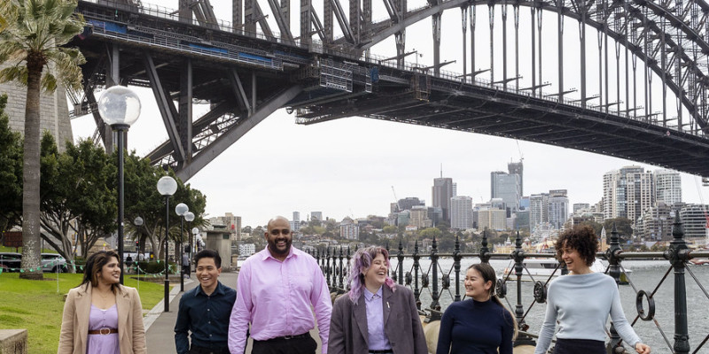 finalists from previous NSW international education awards with sydney harbour bridge