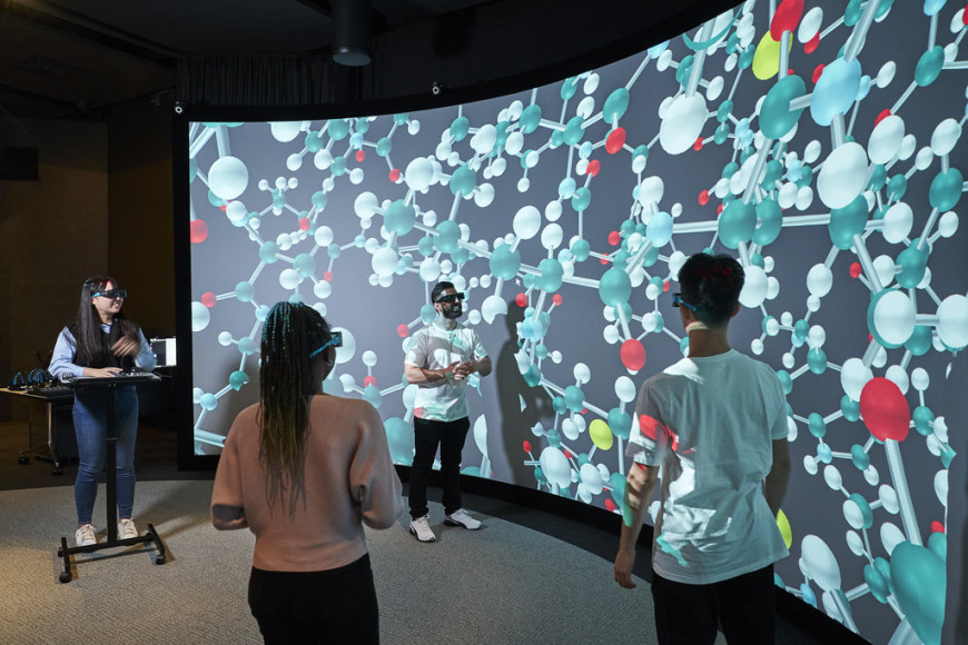 Group of students having fun and exploring virtual reality technology whilst learning